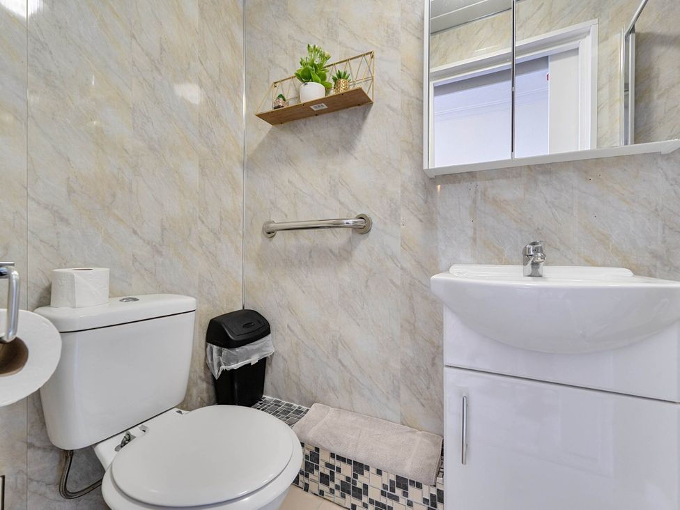 A bathroom with a sink and toilet at Ground Floor Studio Apartment at SeaCote, Bispham
