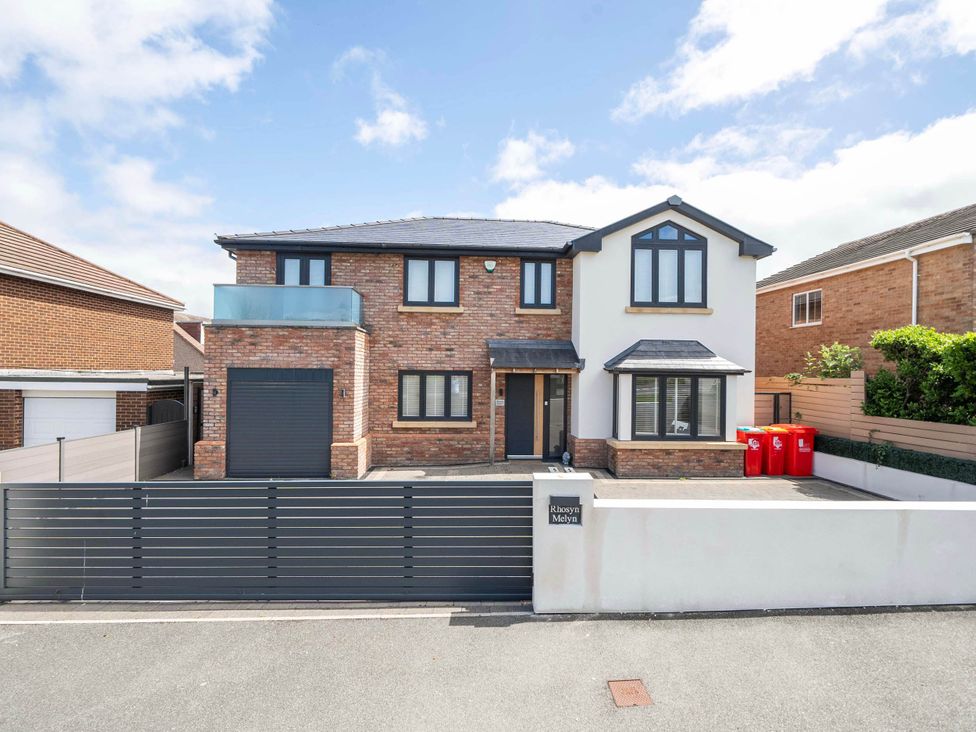 A house with a garage and driveway at Rhosyn Melyn in Abergele