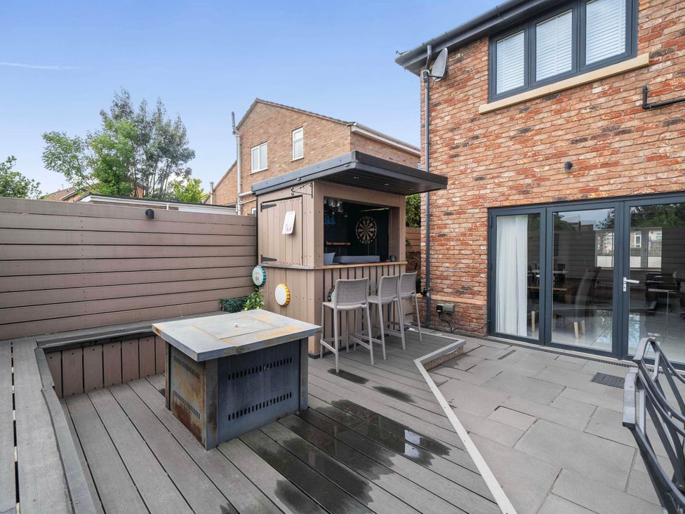 An outdoor area featuring a bar and seating at The Old Barn in Abergele