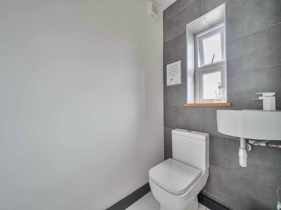 A bathroom with a toilet and sink at The Old Barn in Abergele