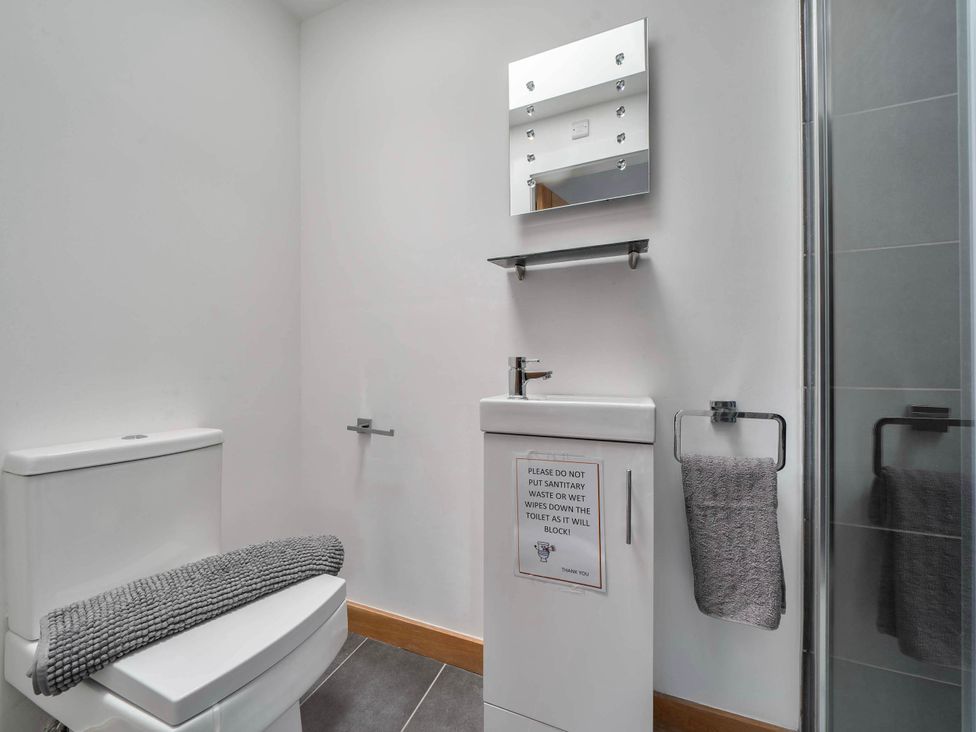 A bathroom with a toilet and sink at The Old Barn in Abergele