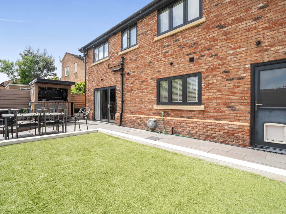 A garden with a patio and seating at 