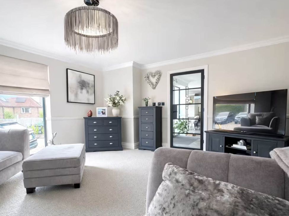 A living room with a sofa, television and chest of drawers at Rochester Retreat Spacious 5 Bedroom House in Higham