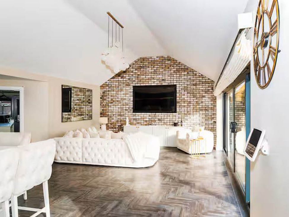 A living room with a sofa and television at Rochester Retreat Spacious 5 Bedroom House in Higham