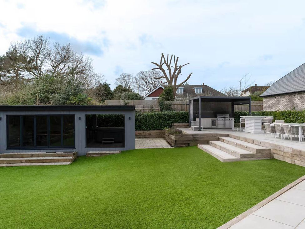 A garden with a deck and outdoor kitchen at Rochester Retreat Spacious 5 Bedroom House in Higham