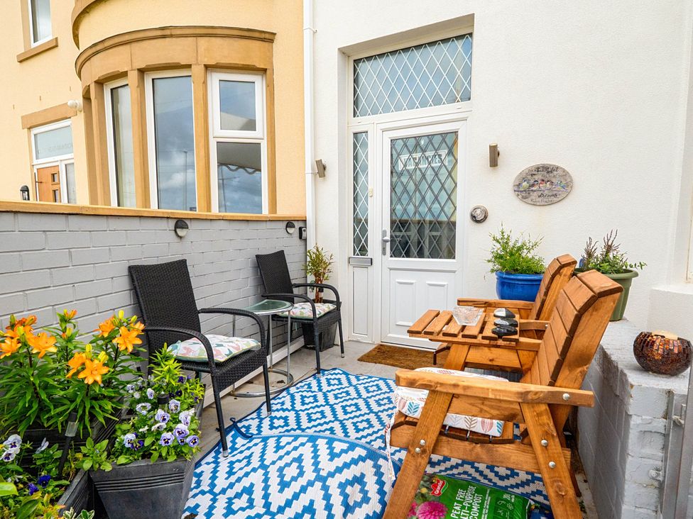 An outdoor patio with chairs and a table at 
