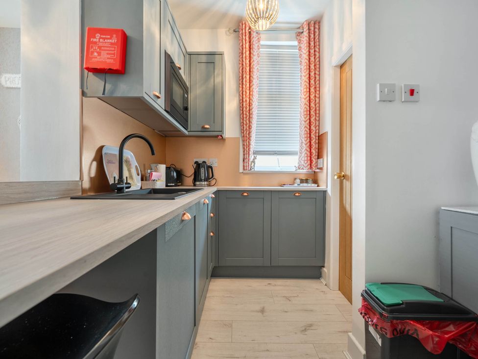 A kitchen with a sink and cabinets at 