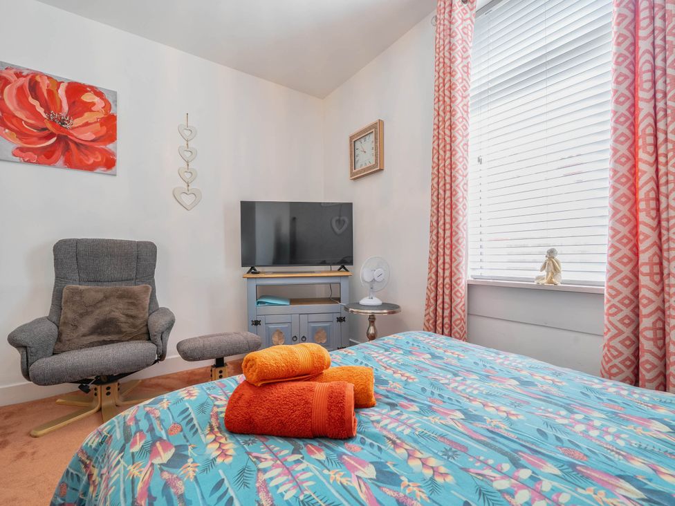 A bedroom with a bed and television at The Old Barn in Manchester
