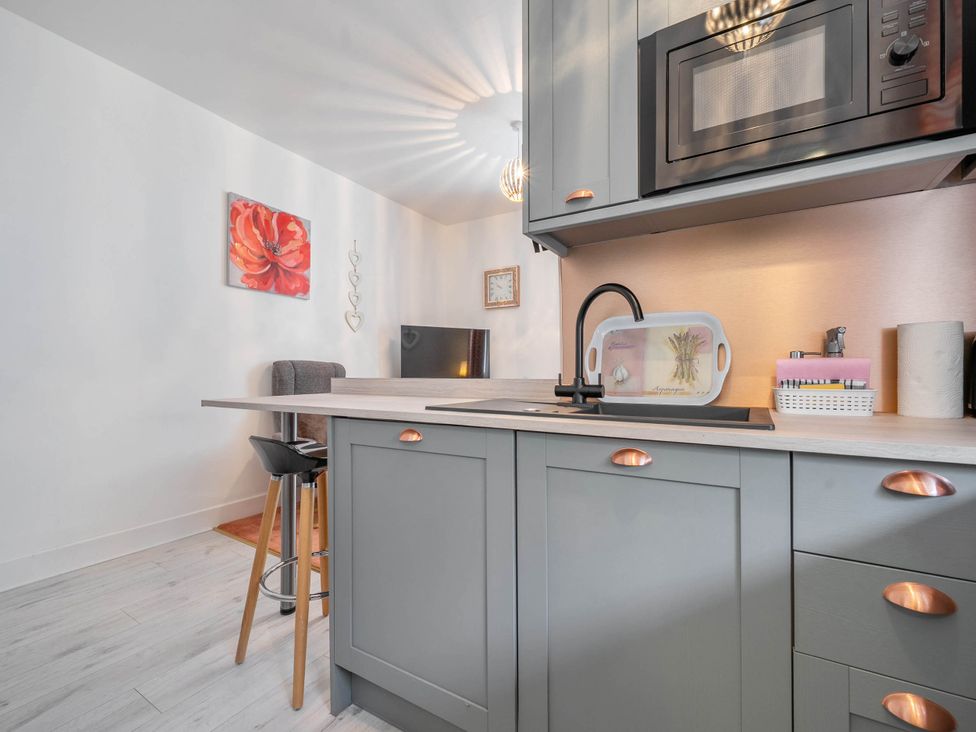 A kitchen with a sink and microwave at The Old Barn in Manchester