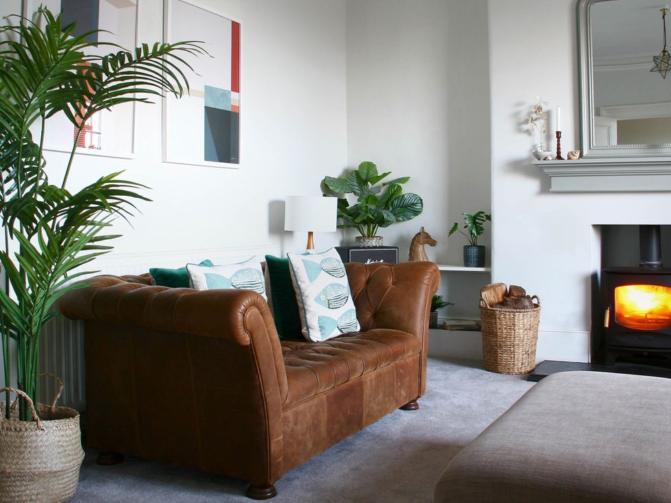 A living room with a leather sofa and fireplace at Beautiful 6Bed Sleeps 12 Stunning Views in Lynton