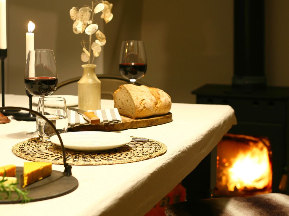 A dining table with bread, cheese, and wine glasses at Beautiful 6Bed Sleeps 12 Stunning Views, Lynton