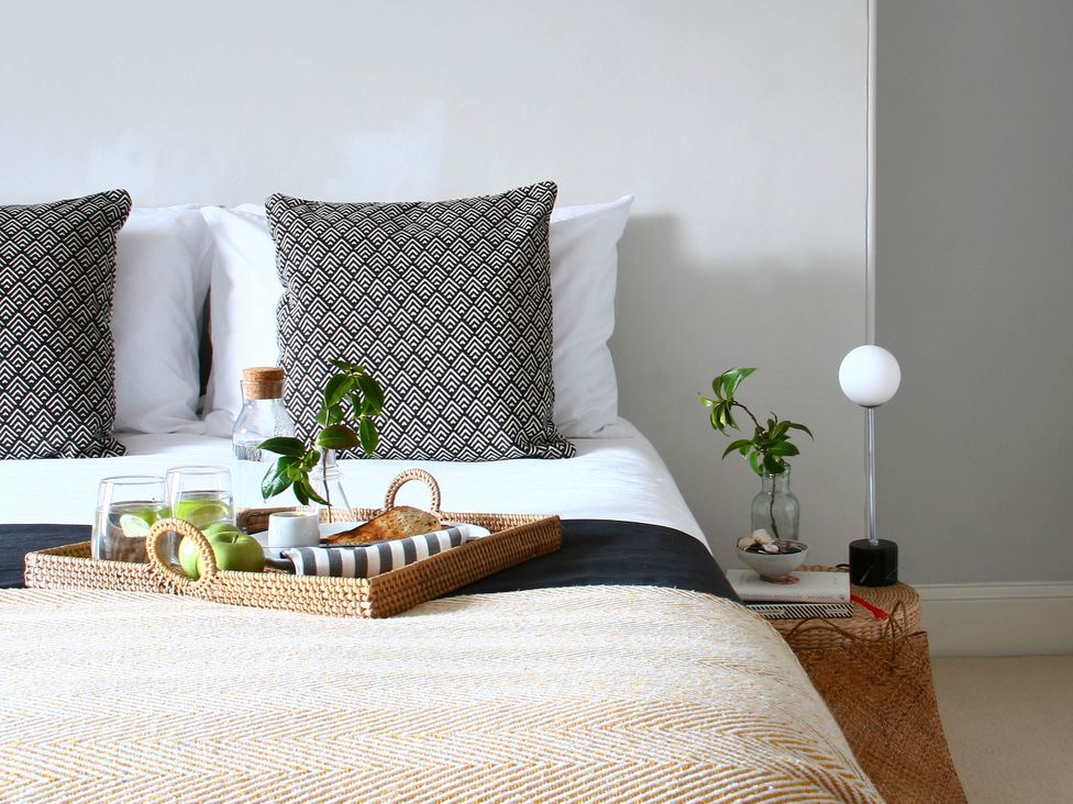A bedroom with a bed and decorative pillows at Beautiful 6Bed Sleeps 12 Stunning Views in Lynton