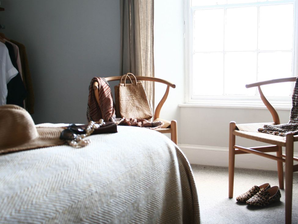 A bedroom with a bed, chairs and a window at Beautiful 6Bed Sleeps 12 Stunning Views, Lynton