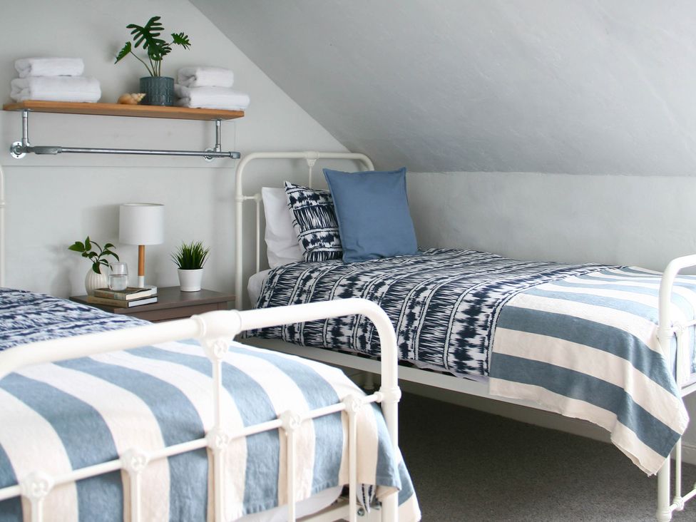 A bedroom with two beds and a nightstand at Beautiful 6Bed Sleeps 12 Stunning Views in Lynton