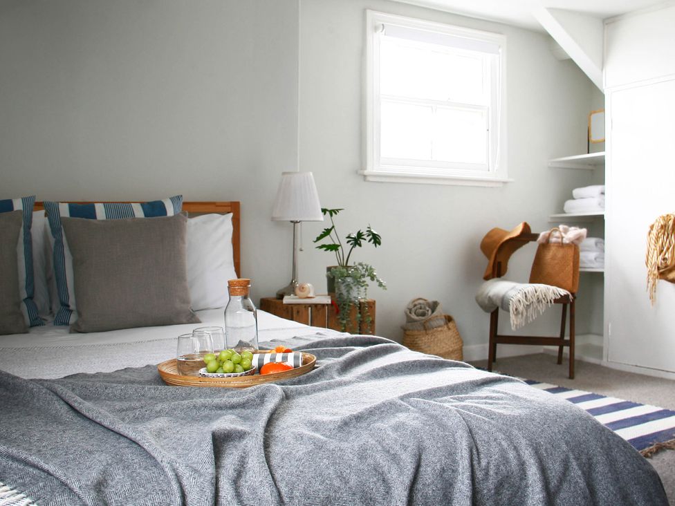 A bedroom with a bed, table and plant at Beautiful 6Bed Sleeps 12 Stunning Views in Lynton