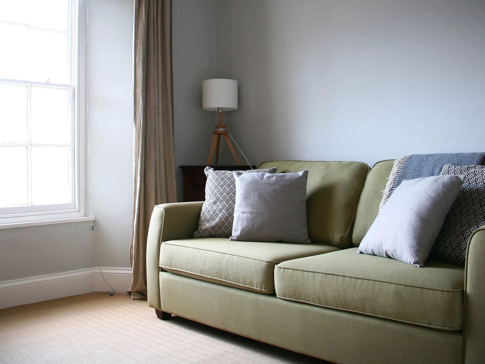 A living room with a sofa and lamp at Beautiful 6Bed Sleeps 12 Stunning Views in Lynton