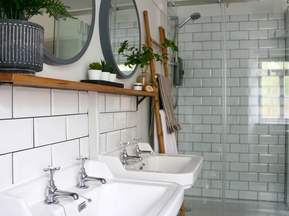 A bathroom with dual washbasins and a shower at Beautiful 6Bed Sleeps 12 Stunning Views in Lynton