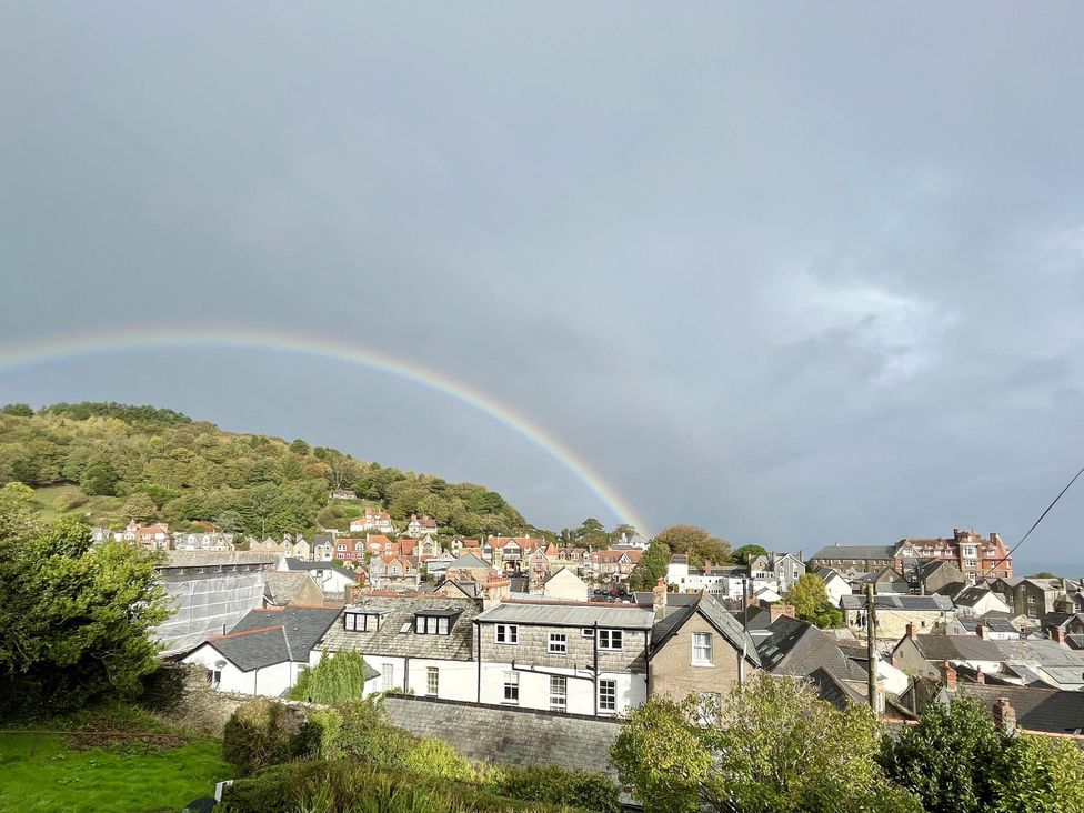 A view of houses and a rainbow over a hill at Beautiful 6Bed Sleeps 12 Stunning Views in Lynton