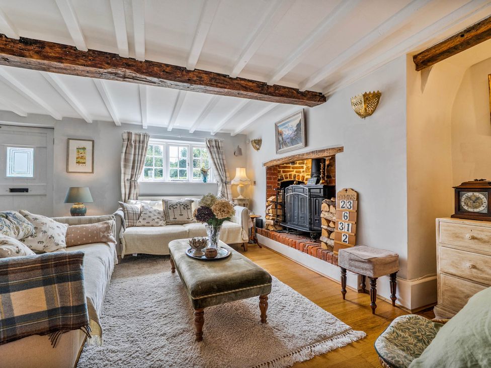 A living room with a fireplace and seating area at Cottage Sleeps 4 with Enclosed Garden Turville near Henley-On-Thames