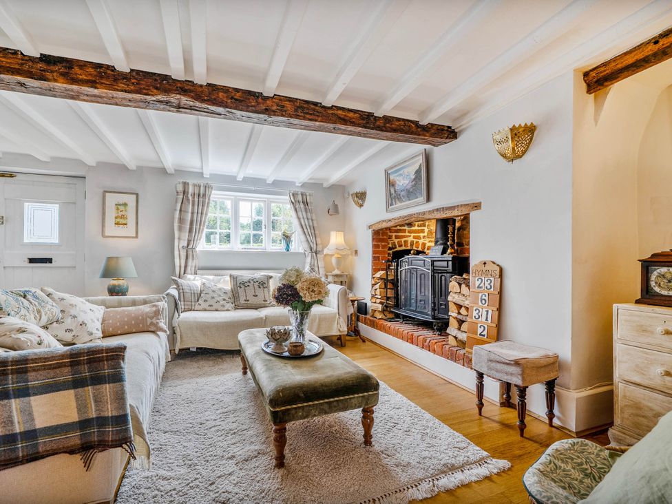 A living room with a fireplace and seating arrangements at Cottage Sleeps 4 with Enclosed Garden, Turville near Henley-On-Thames