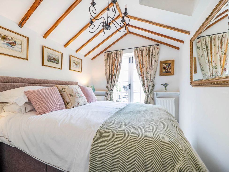 A bedroom with a bed and decorative curtains at Cottage Sleeps 4 with Enclosed Garden Turville near Henley-On-Thames