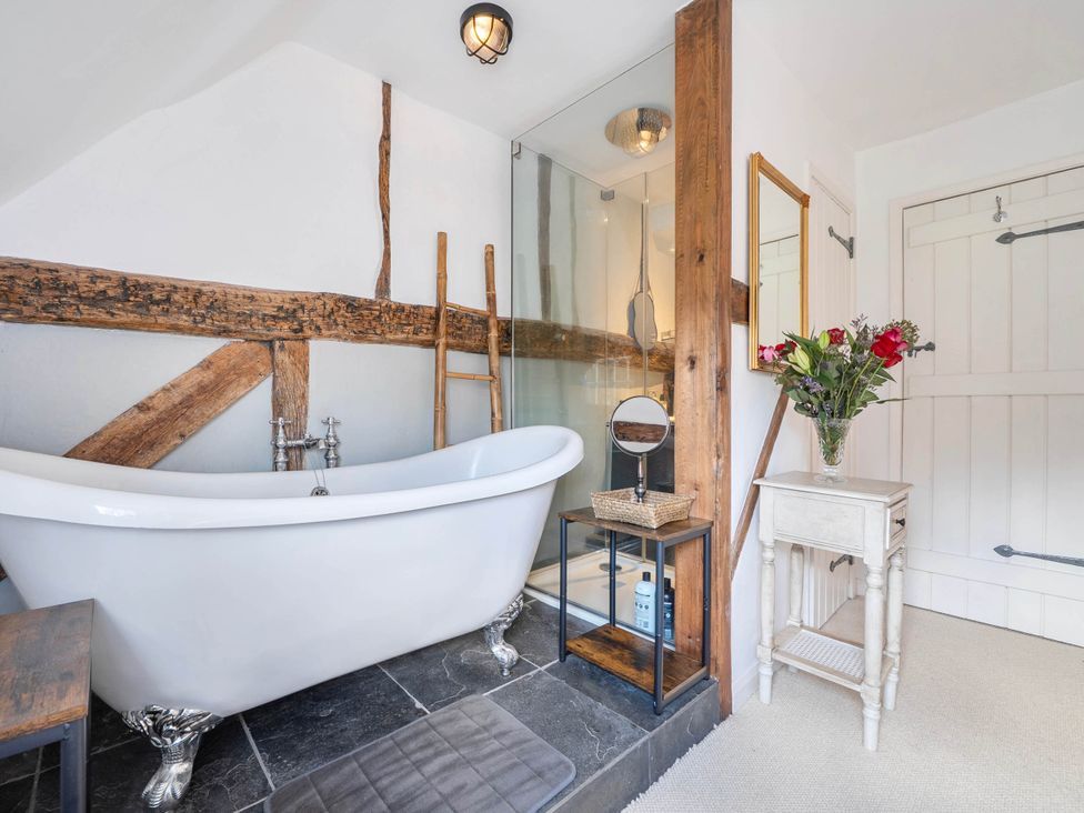 A bathroom with a bathtub and shower at Cottage Sleeps 4 with Enclosed Garden in Turville near Henley-On-Thames