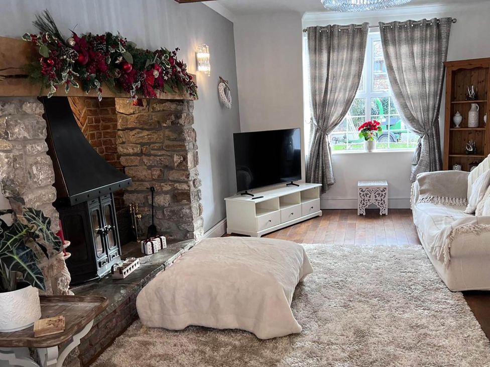 A living room with a fireplace and television at Build your memories hot tub garden sleeps 14 Nottage