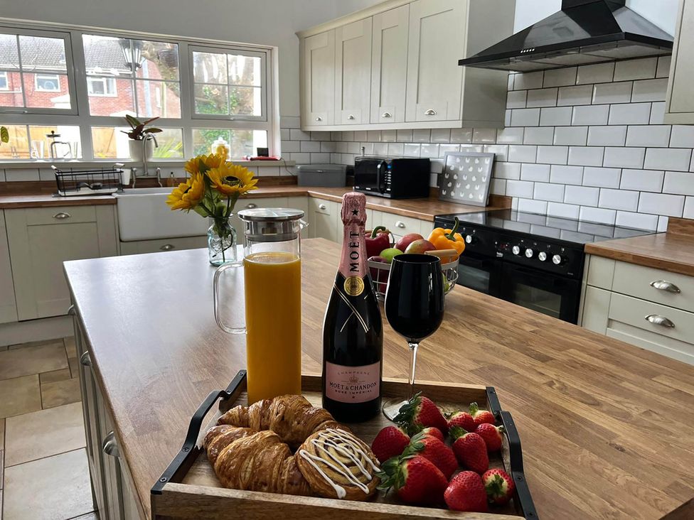 A kitchen with food and drinks on a tray at Build your memories hot tub garden sleeps 14 in Nottage
