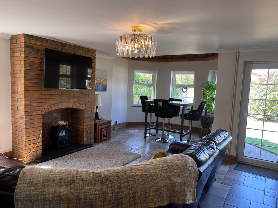 A living room with a television and dining area at Build your memories hot tub garden sleeps 14 Nottage