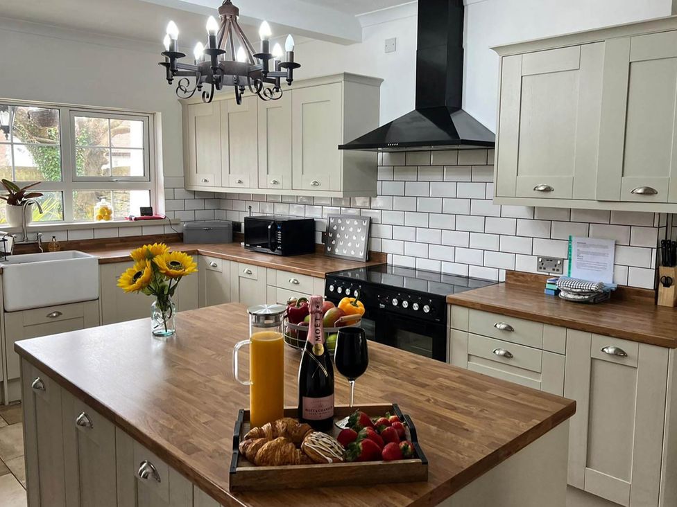 A kitchen with a countertop, sink, and various food items at Build your memories hot tub garden sleeps 14 in Nottage