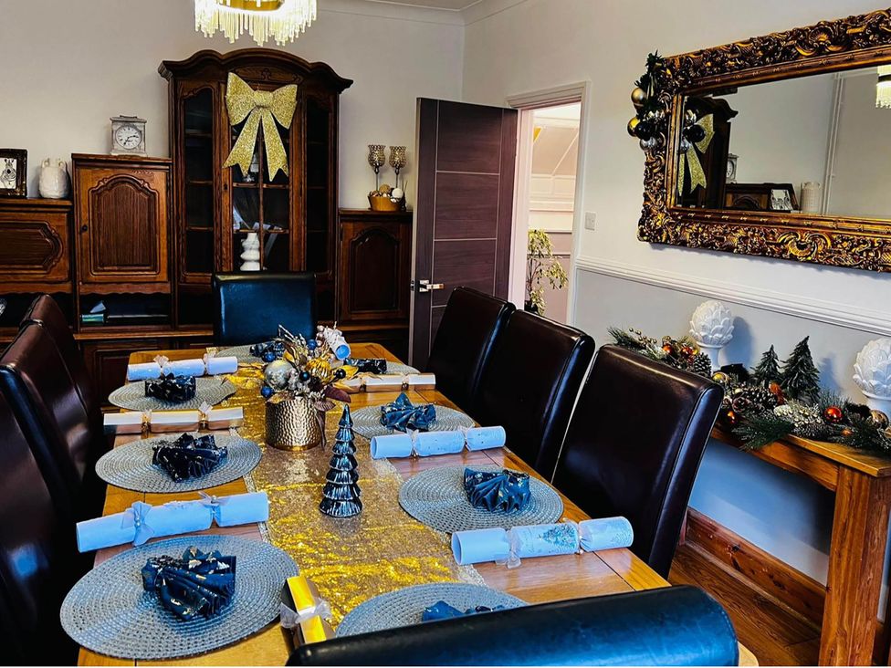 A dining room with a table set for a meal at Build your memories hot tub garden sleeps 14 Nottage