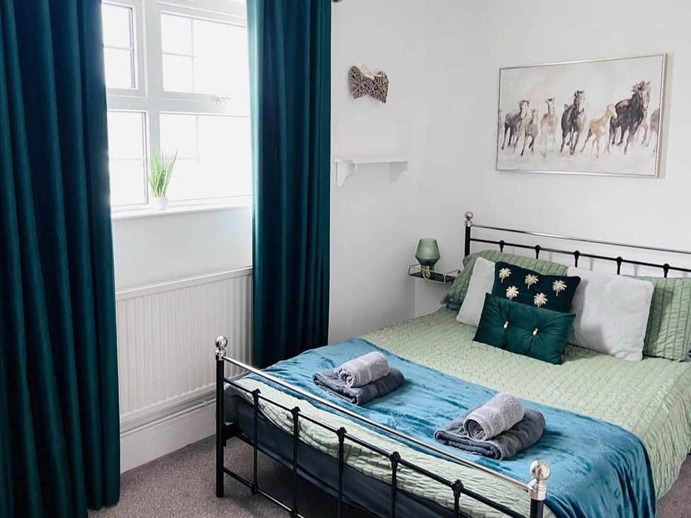 A bedroom with a bed and pillows at Build your memories hot tub garden sleeps 14 Nottage