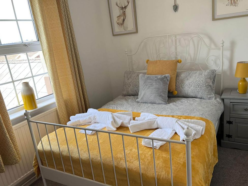 A bedroom with a bed and pillows at Build your memories hot tub garden sleeps 14 Nottage