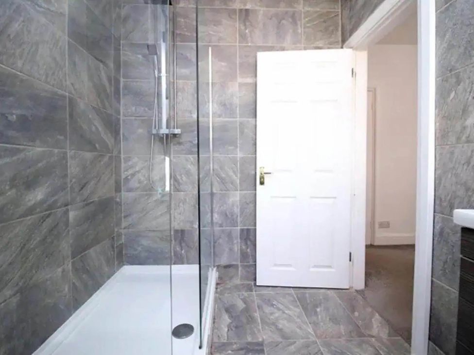 A bathroom with a shower and a door at Build your memories hot tub garden sleeps 14 Nottage