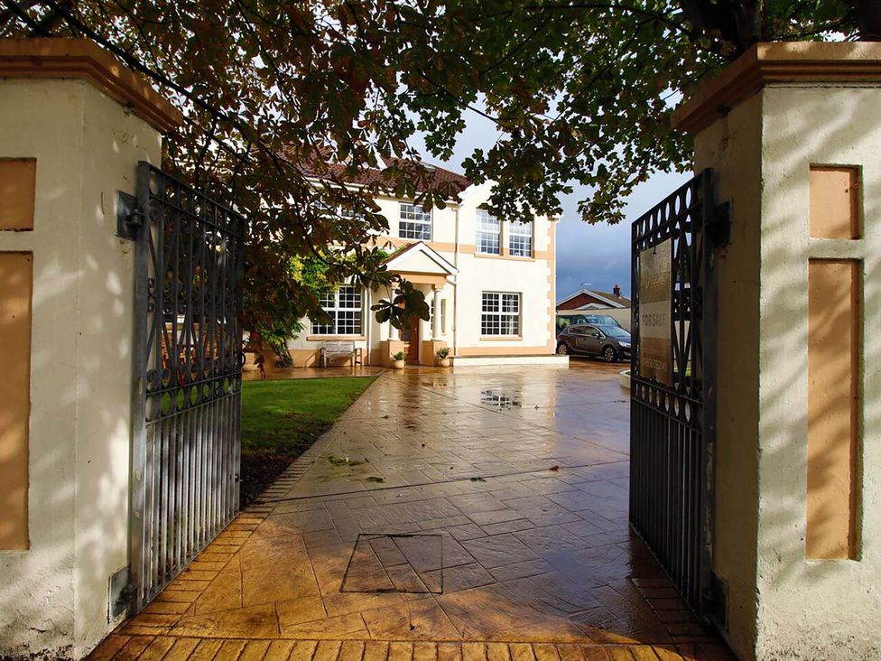 An exterior view of a house with a driveway and gate at Build your memories hot tub garden sleeps 14 Nottage