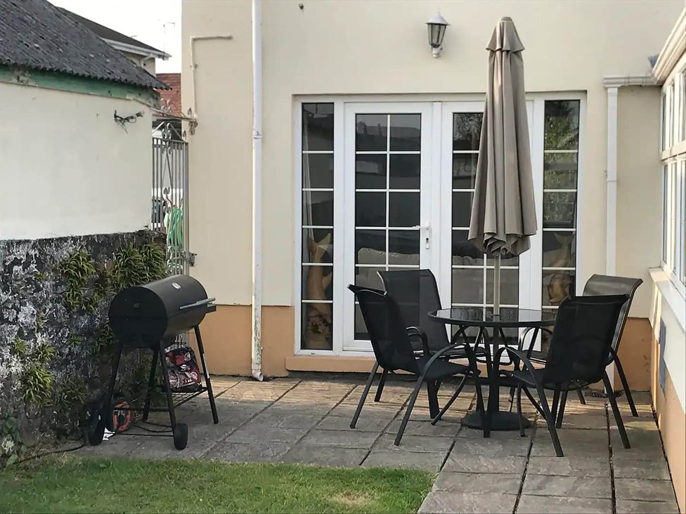 An outdoor seating area with a table and chairs at Build your memories hot tub garden sleeps 14 in Nottage