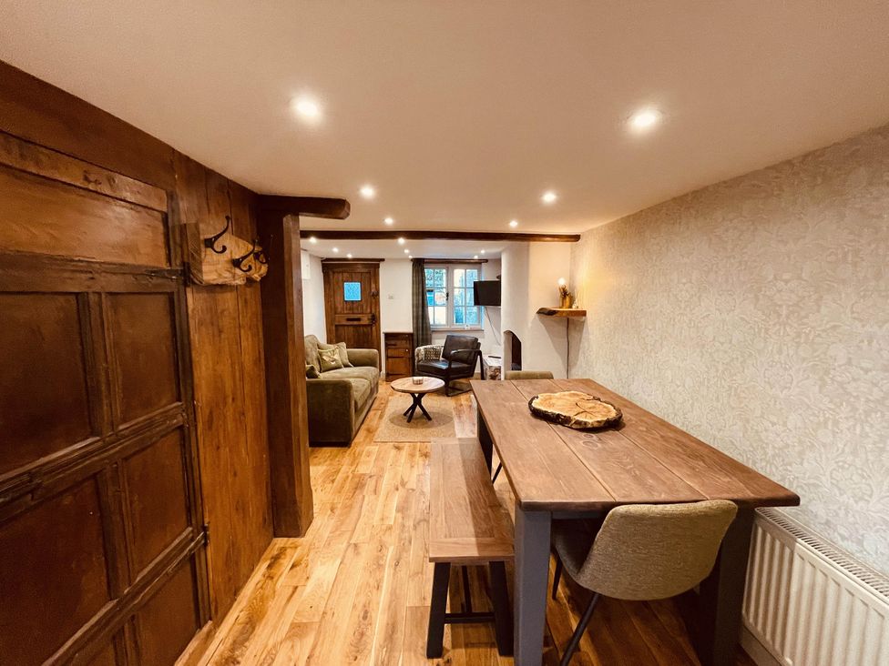 A living room with a sofa and dining table at Charming Cottage Sleeps 4 with Sauna in Shaftesbury