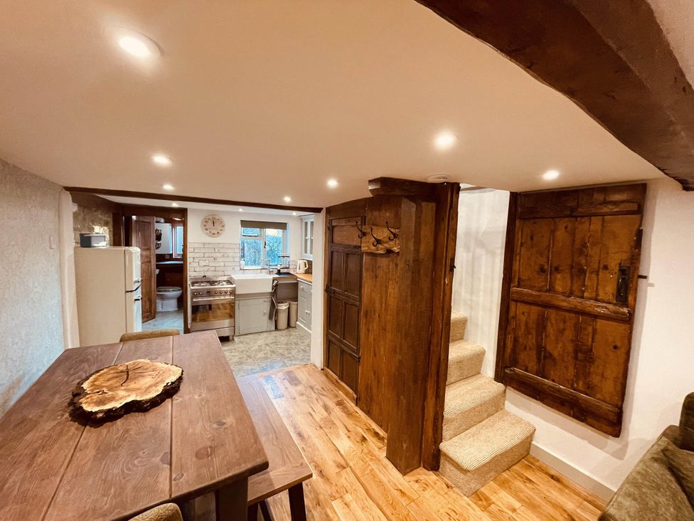 A kitchen area with a dining table and appliances at Charming Cottage Sleeps 4 with Sauna in Shaftesbury