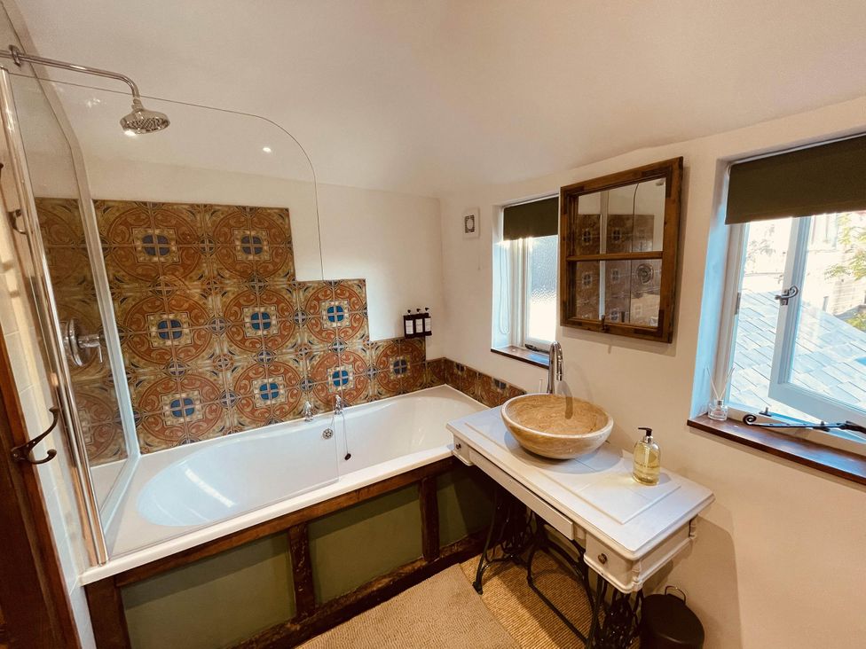 A bathroom with a bathtub and sink at Charming Cottage Sleeps 4 with Sauna in Shaftesbury