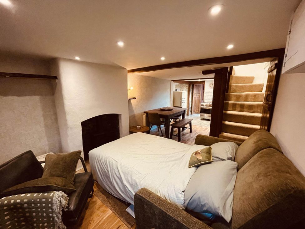 A living room with a bed and table at Charming Cottage Sleeps 4 with Sauna in Shaftesbury