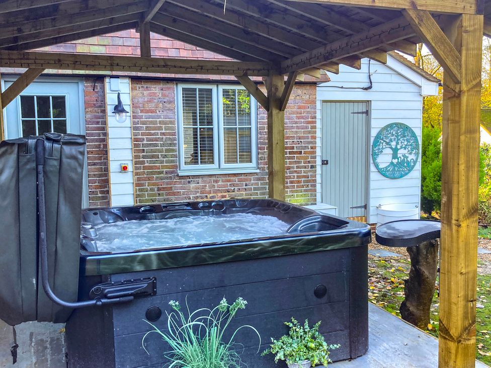 An outdoor area with a hot tub and a wooden structure at 5Bed 10Guests Fireplace HotTub Pets ok Parking in Battle