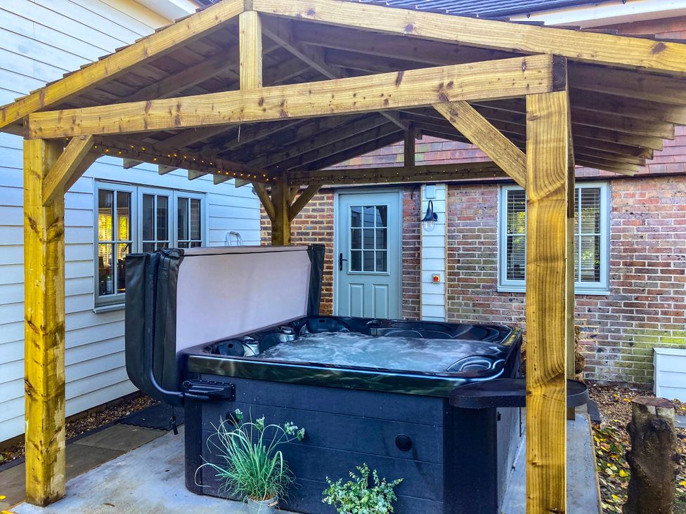 A hot tub under a wooden gazebo at 5Bed 10Guests Fireplace HotTub Pets ok Parking in Battle