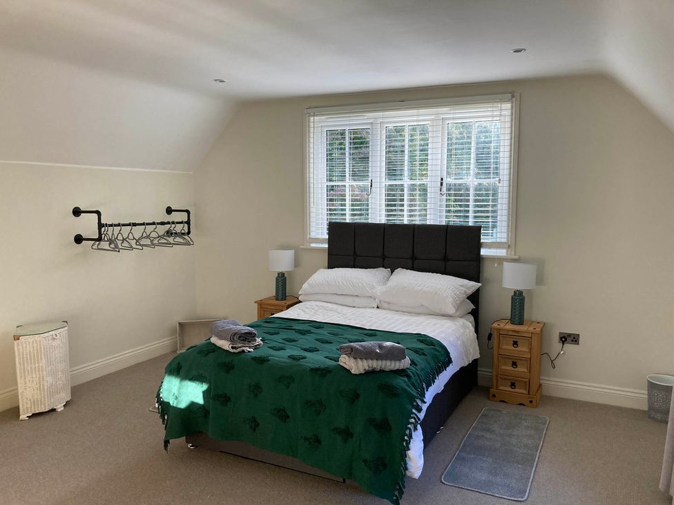 A bedroom with a bed and nightstand at 5Bed 10Guests Fireplace HotTub Pets ok Parking in Battle