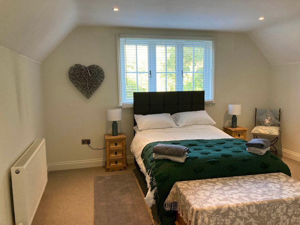 A bedroom with a bed and two nightstands at 5Bed 10Guests Fireplace HotTub Pets ok Parking in Battle