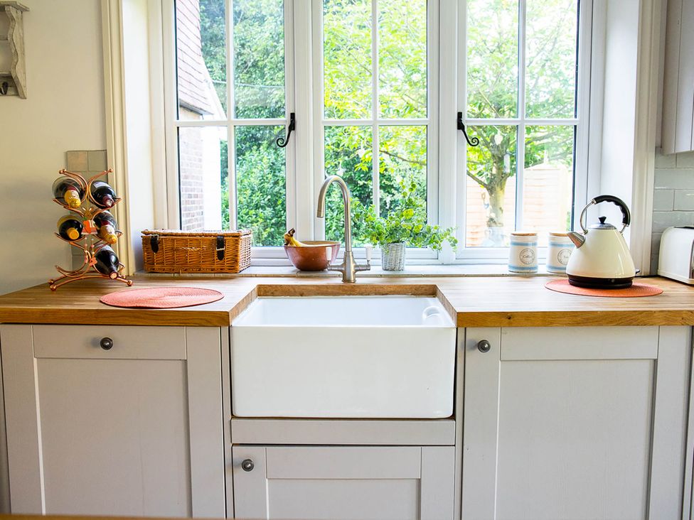 A kitchen with a sink and wine rack at 5Bed 10Guests Fireplace HotTub Pets ok Parking in Battle