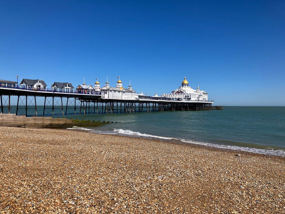 A pier extending over the sea with a beach in the foreground at 5Bed 10Guests Fireplace HotTub Pets ok Parking Battle