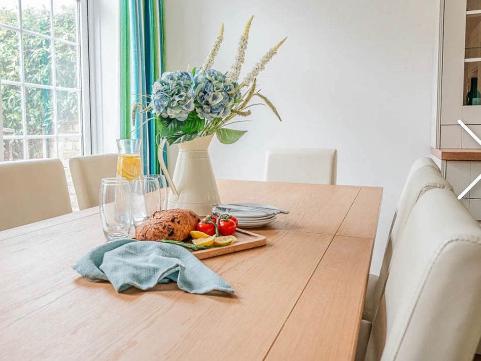 A dining table set with food and drinks at 3 bedroom house 3mins to beach PetsOk Milford On Sea