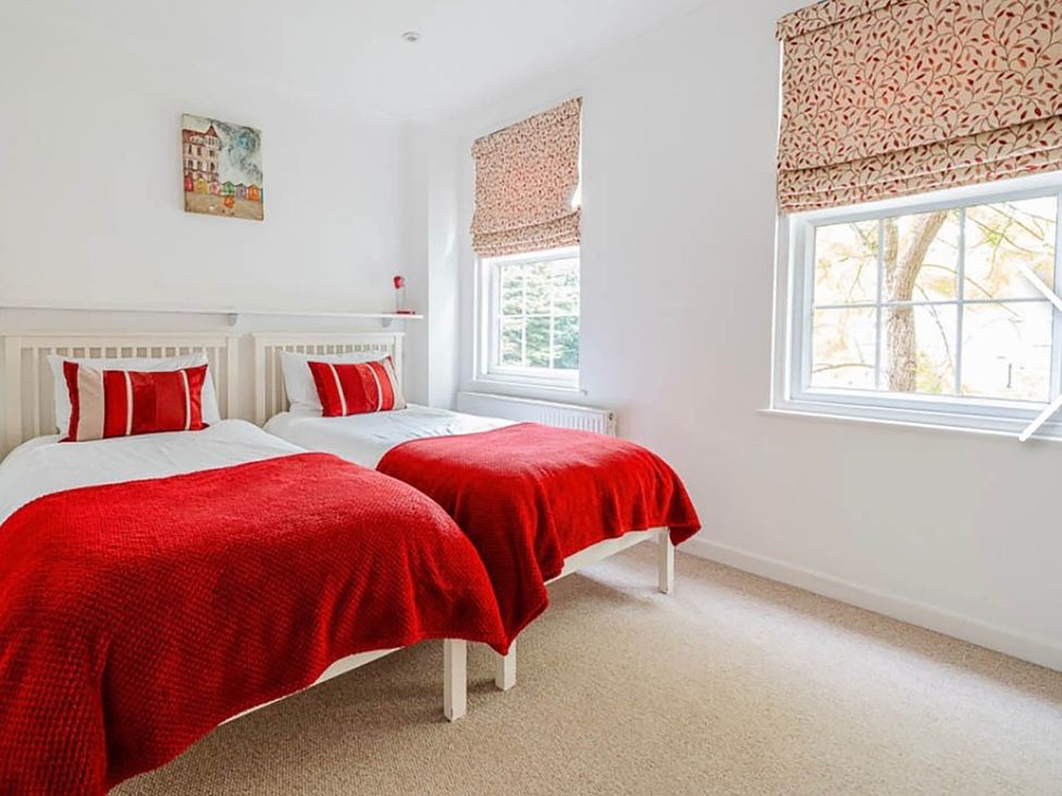 A bedroom with two beds and a window at 3 bedroom house 3mins to beach PetsOk in Milford On Sea