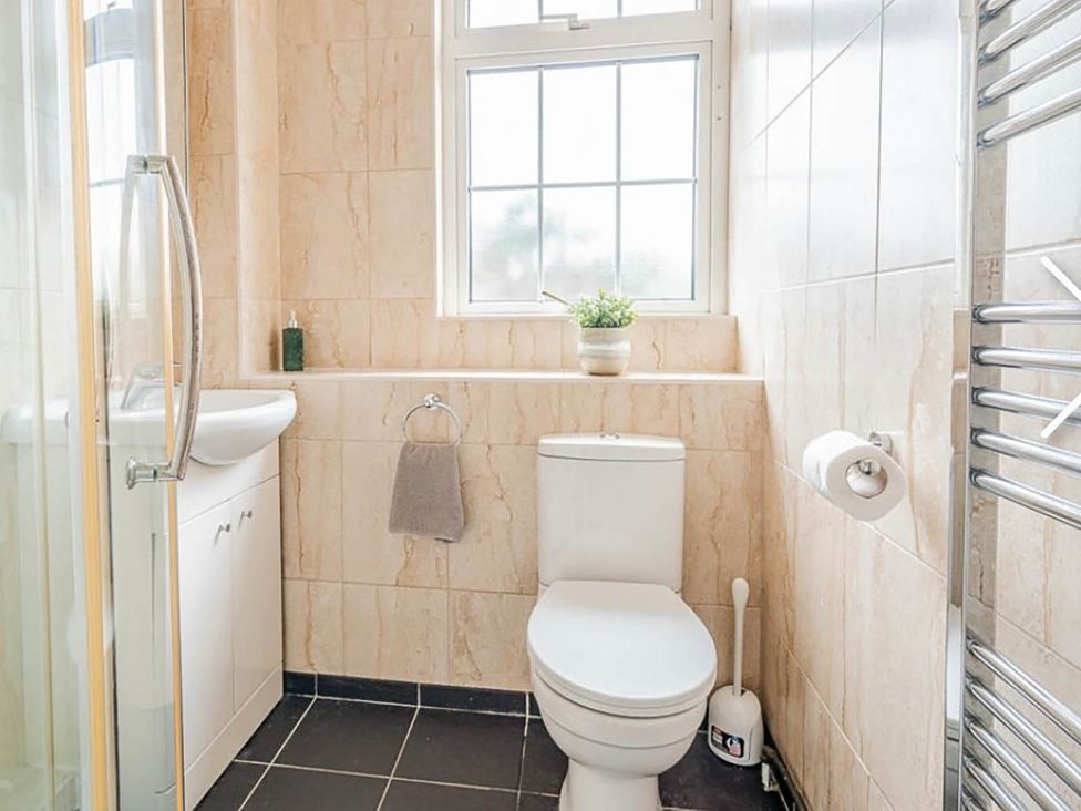 A bathroom with a toilet, sink, and shower at 3 bedroom house 3mins to beach PetsOk in Milford On Sea
