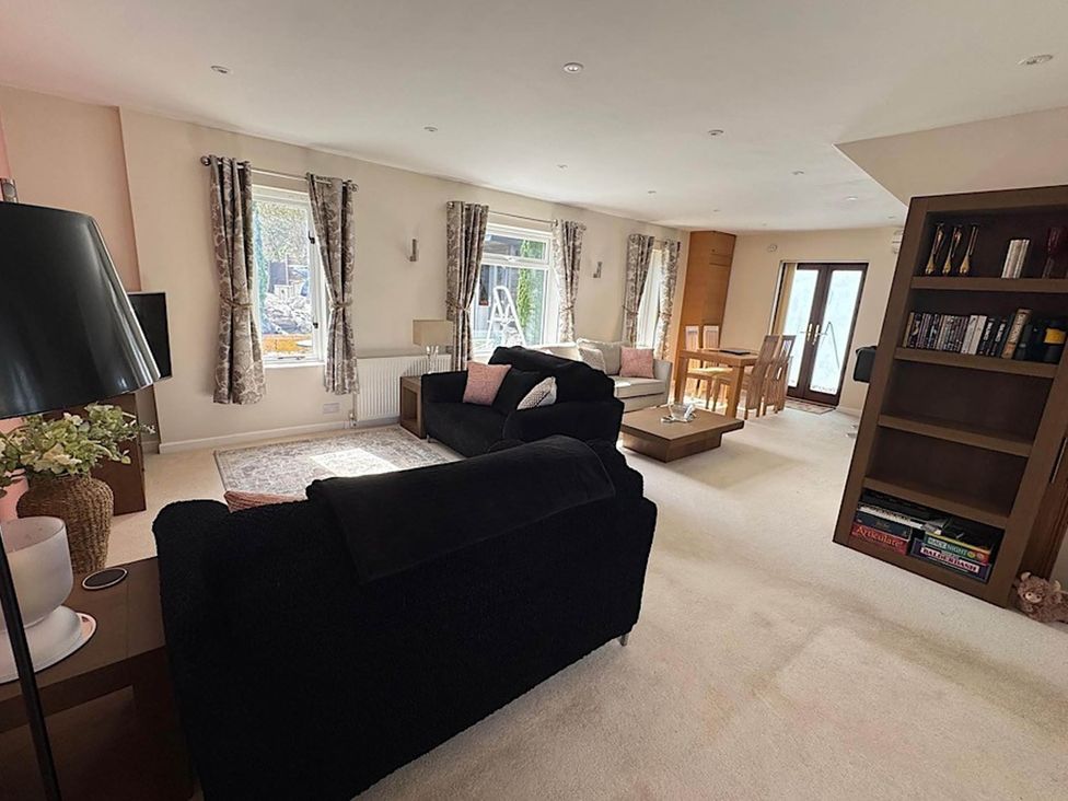 A living room with a sofa and dining area at River Tamar Couples Retreat Dog Friendly in Newbridge